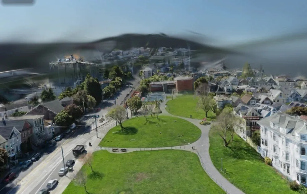Gaussian splat render of Duboce Park from drone height, looking across the lawn and surrounding houses toward a hill, with the sky and the far hill partly unresolved